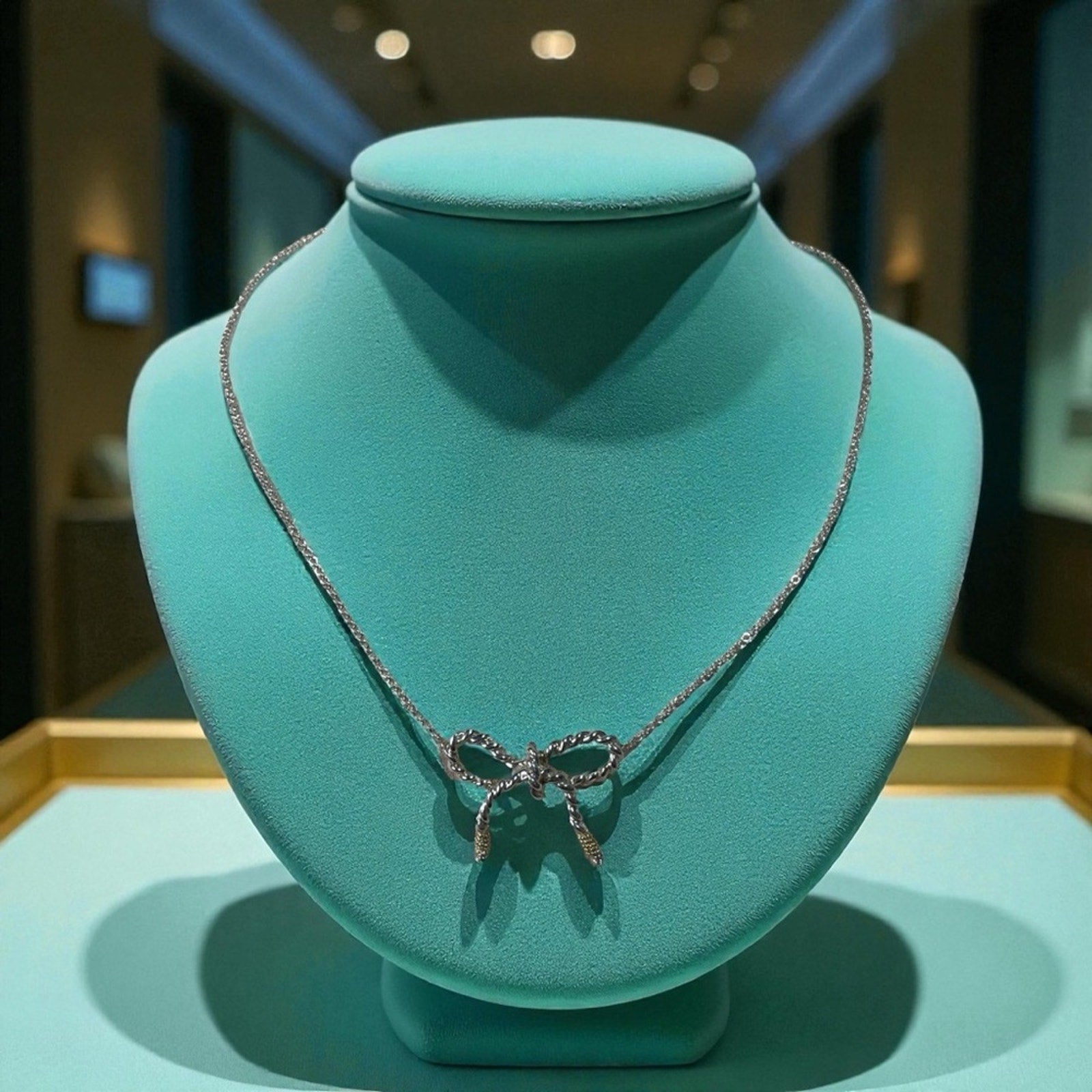Tiffany & Co. 925 sterling silver and 750 Gold twist bow ribbon necklace.